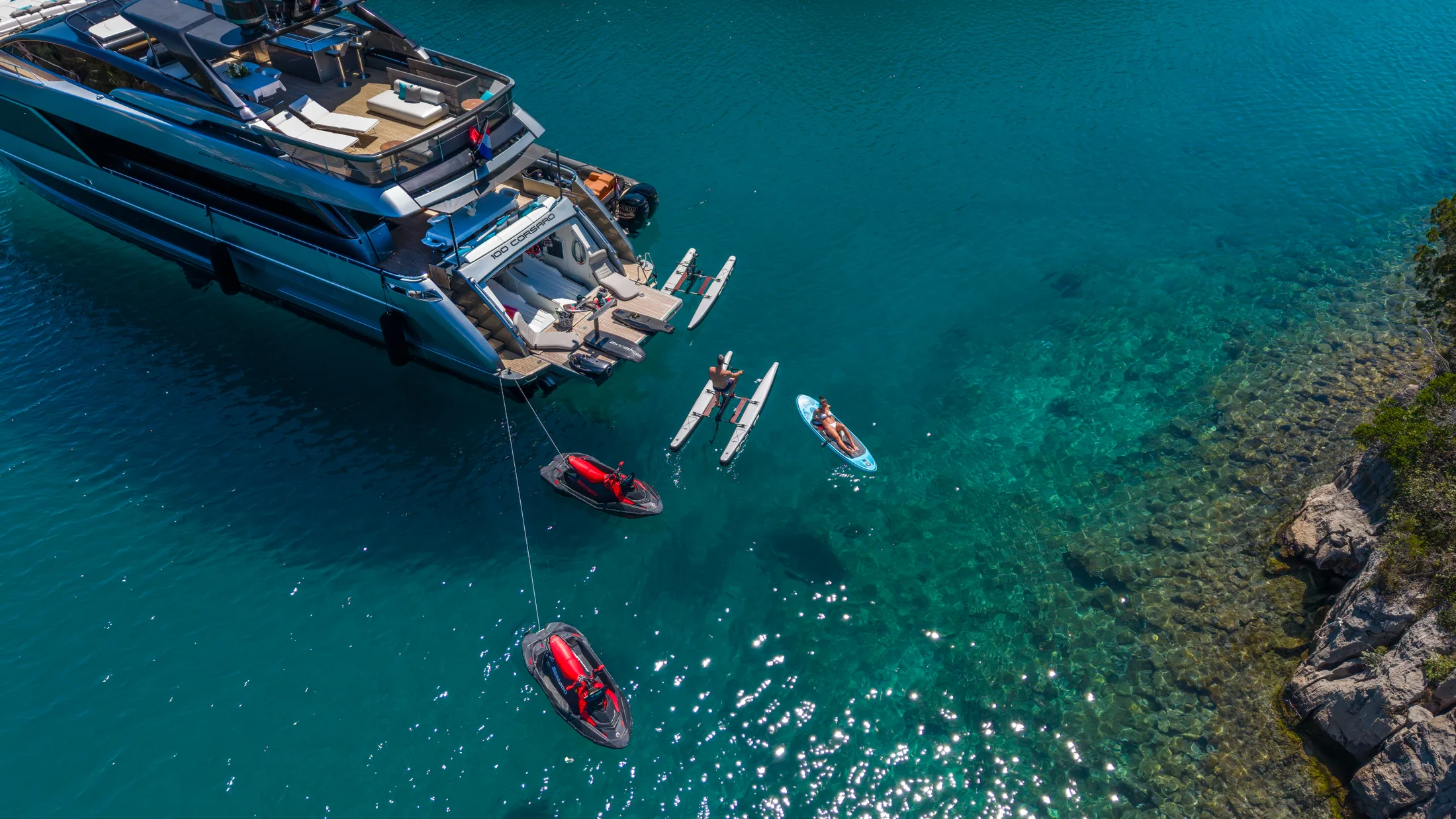 Paddleboards and water toys off the stern of YOYITA II